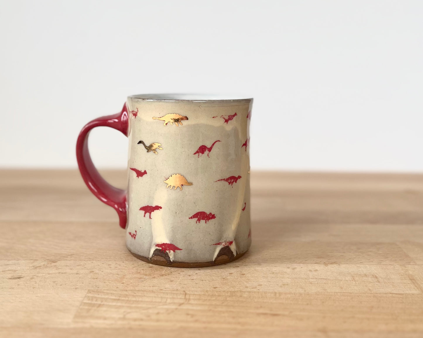 Mug with small red and gold dinos