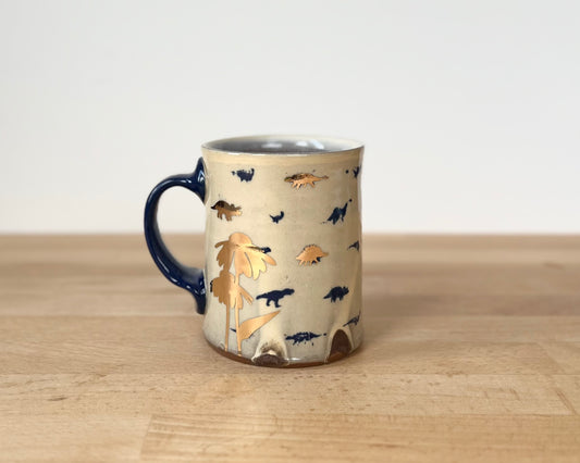 Mug with small blue and gold dinos and coneflower