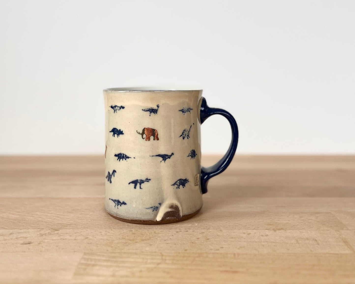 Mug with small blue and gold dinos and coneflower