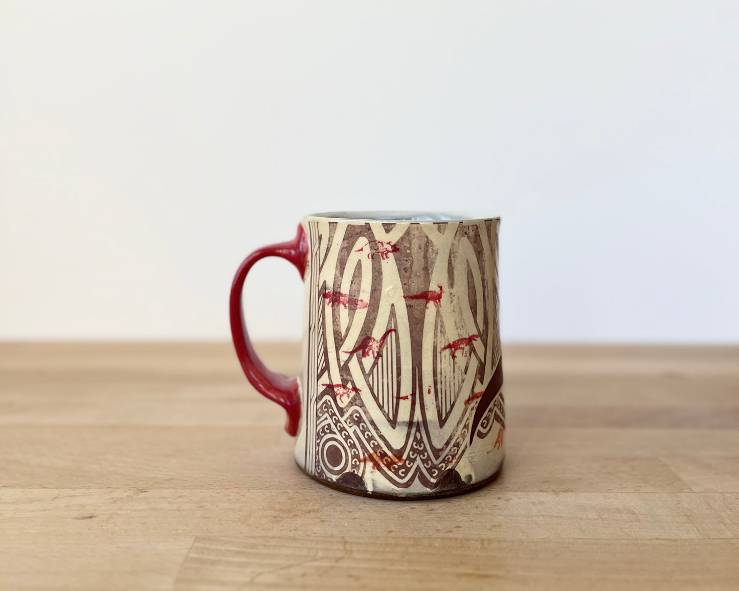 Mug with small red dinos with T-Rex