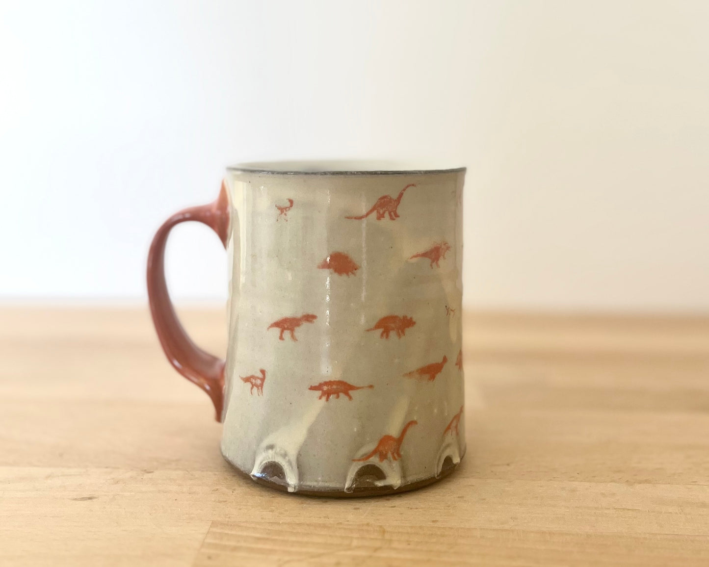 Mug with small orange dinos