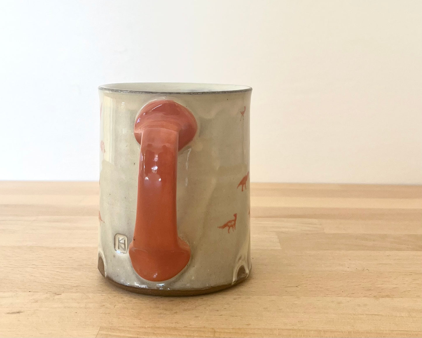 Mug with small orange dinos