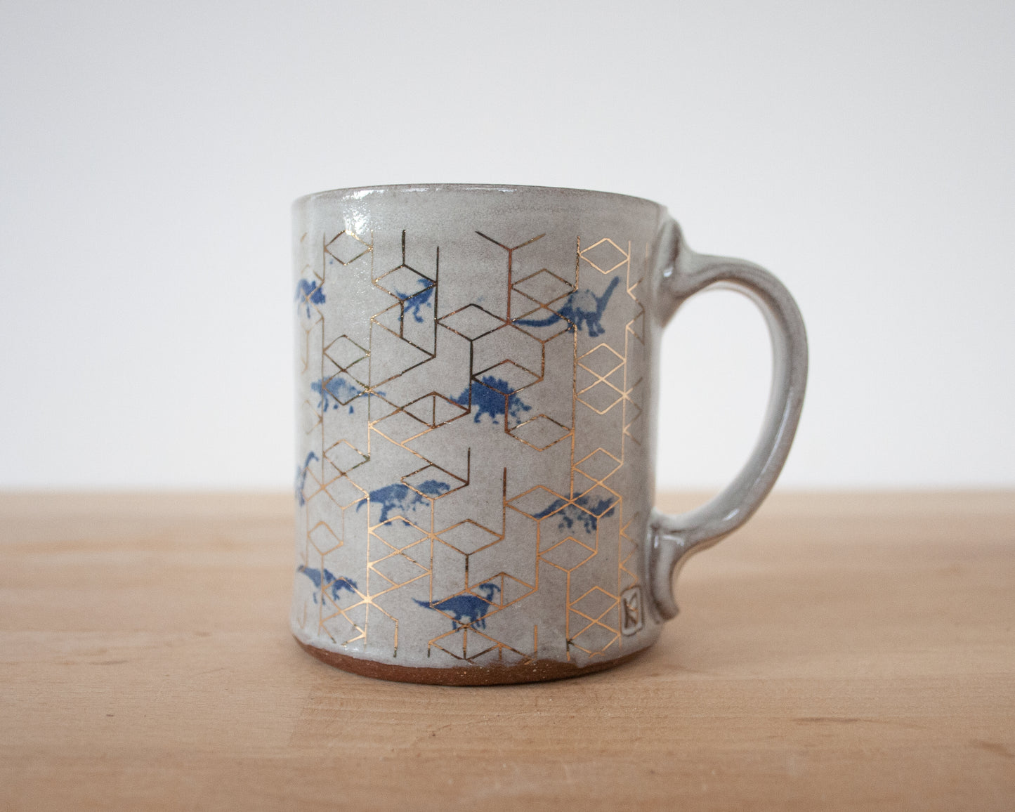 Gold Stegosaurus Mug with small blue dinos