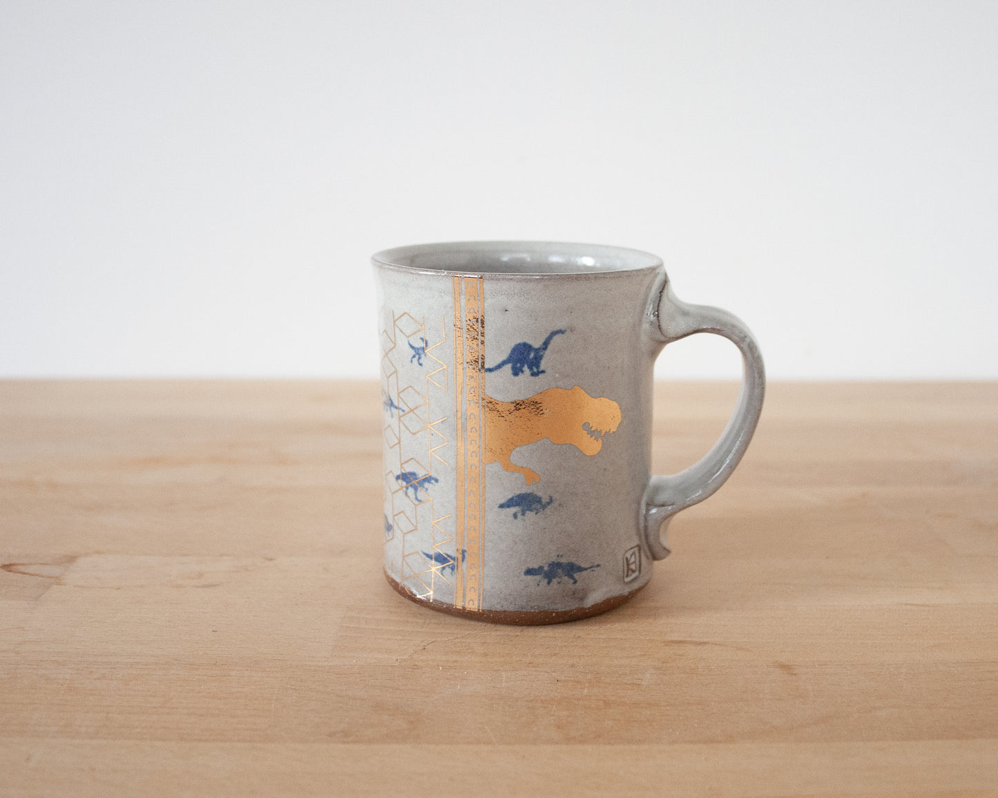 Gold T-Rex Mug with small blue dinos