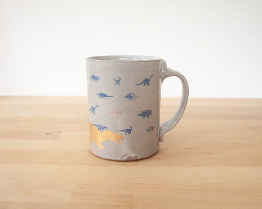 Gold Dinosaur Mug with small blue and red dinos