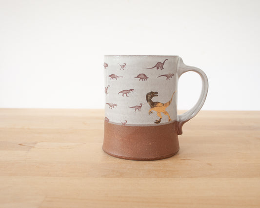 Gold Velociraptor mug with little dinosaurs