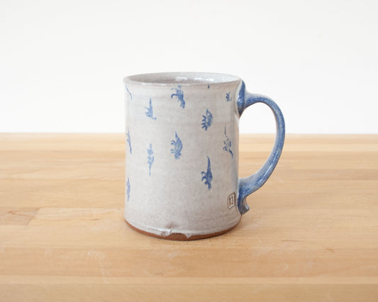 Mug with small blue dinosaurs