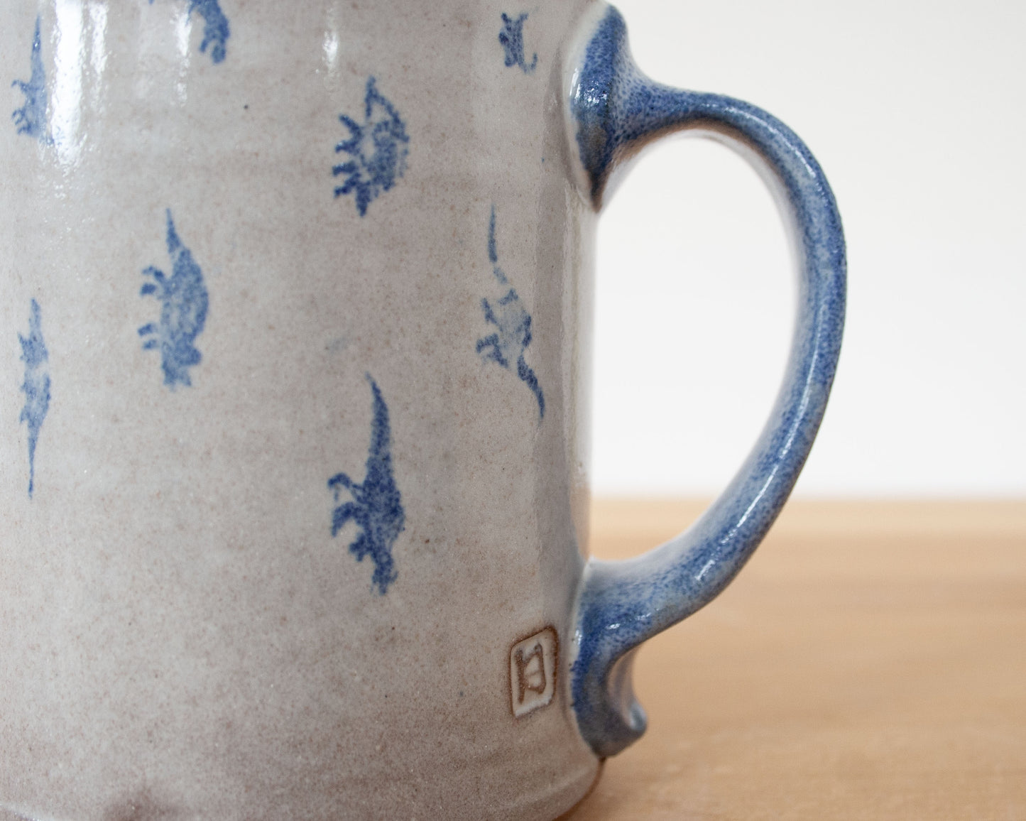 Mug with small blue dinosaurs