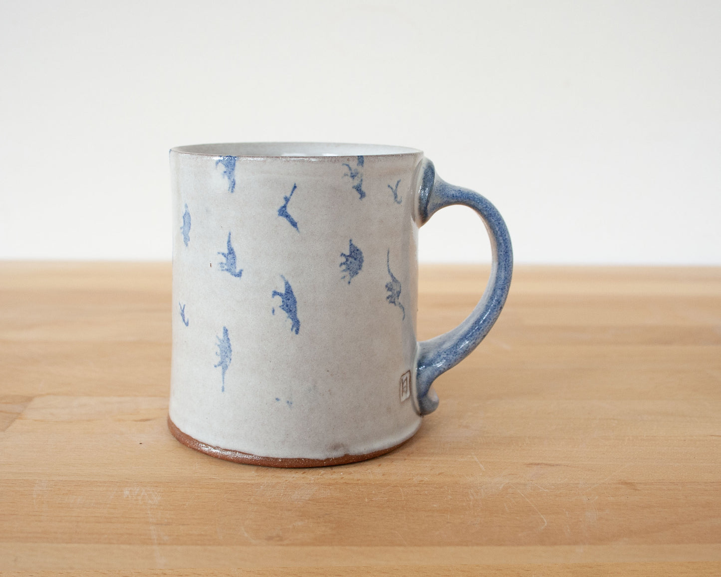 Mug with small blue dinosaurs