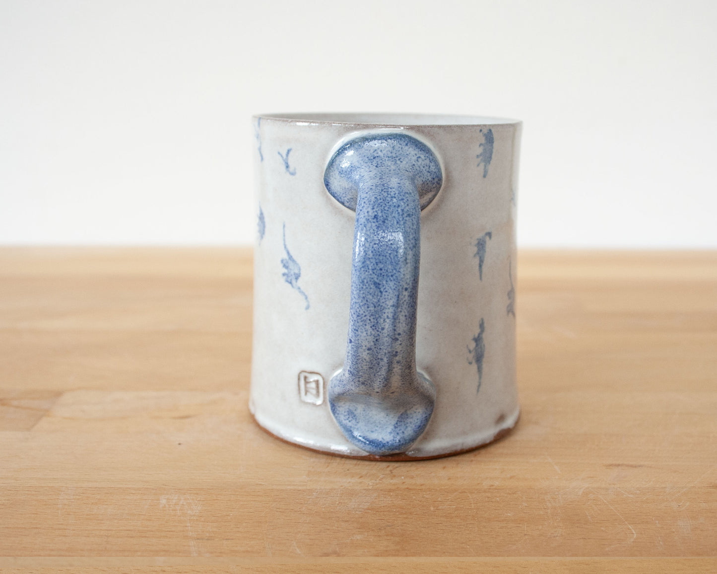 Mug with small blue dinosaurs