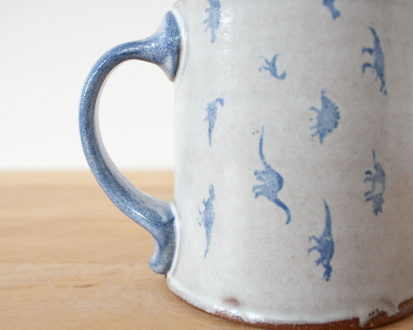 Mug with small blue dinosaurs