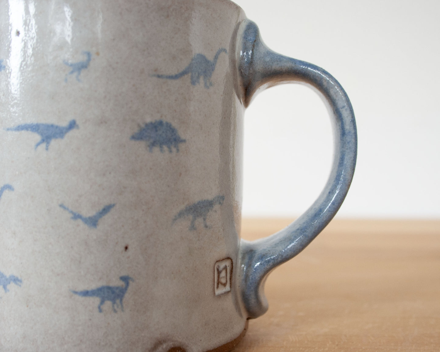 Mug with small blue dinosaurs