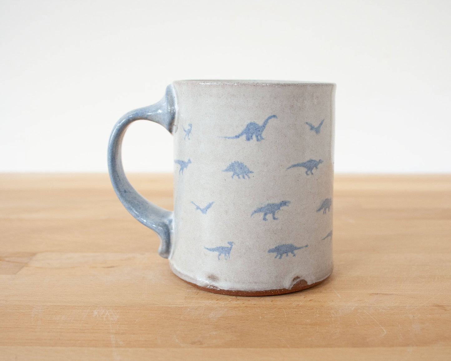 Mug with small blue dinosaurs