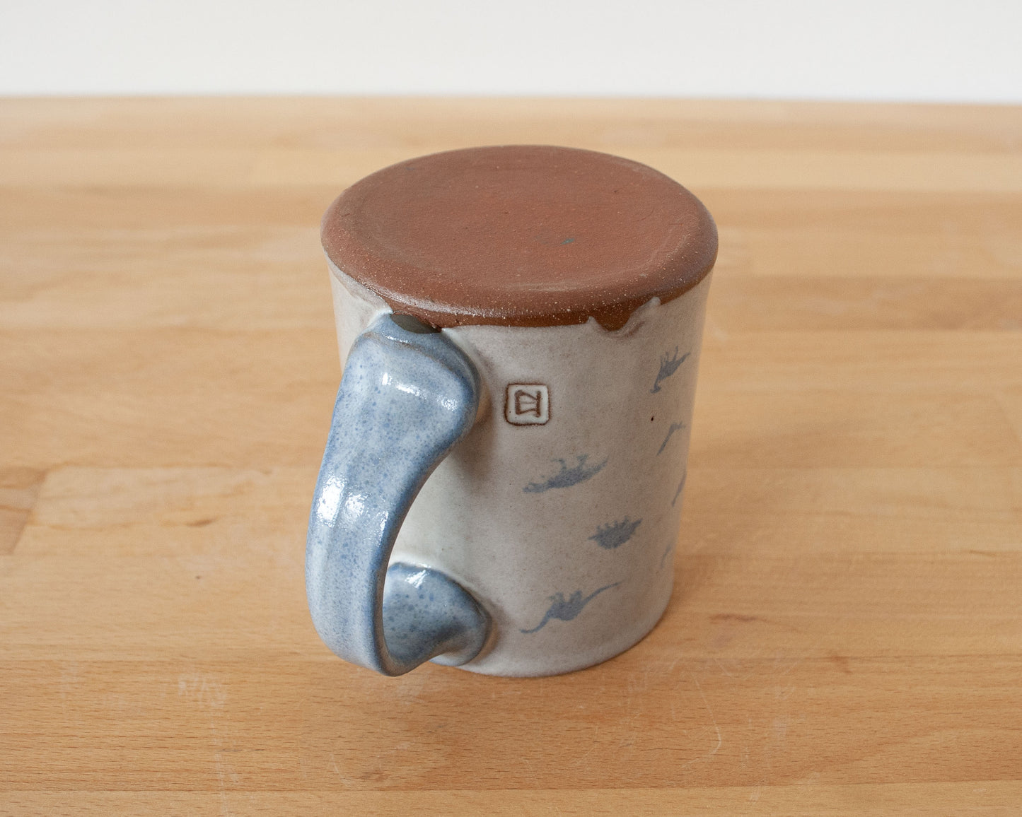 Mug with small blue dinosaurs