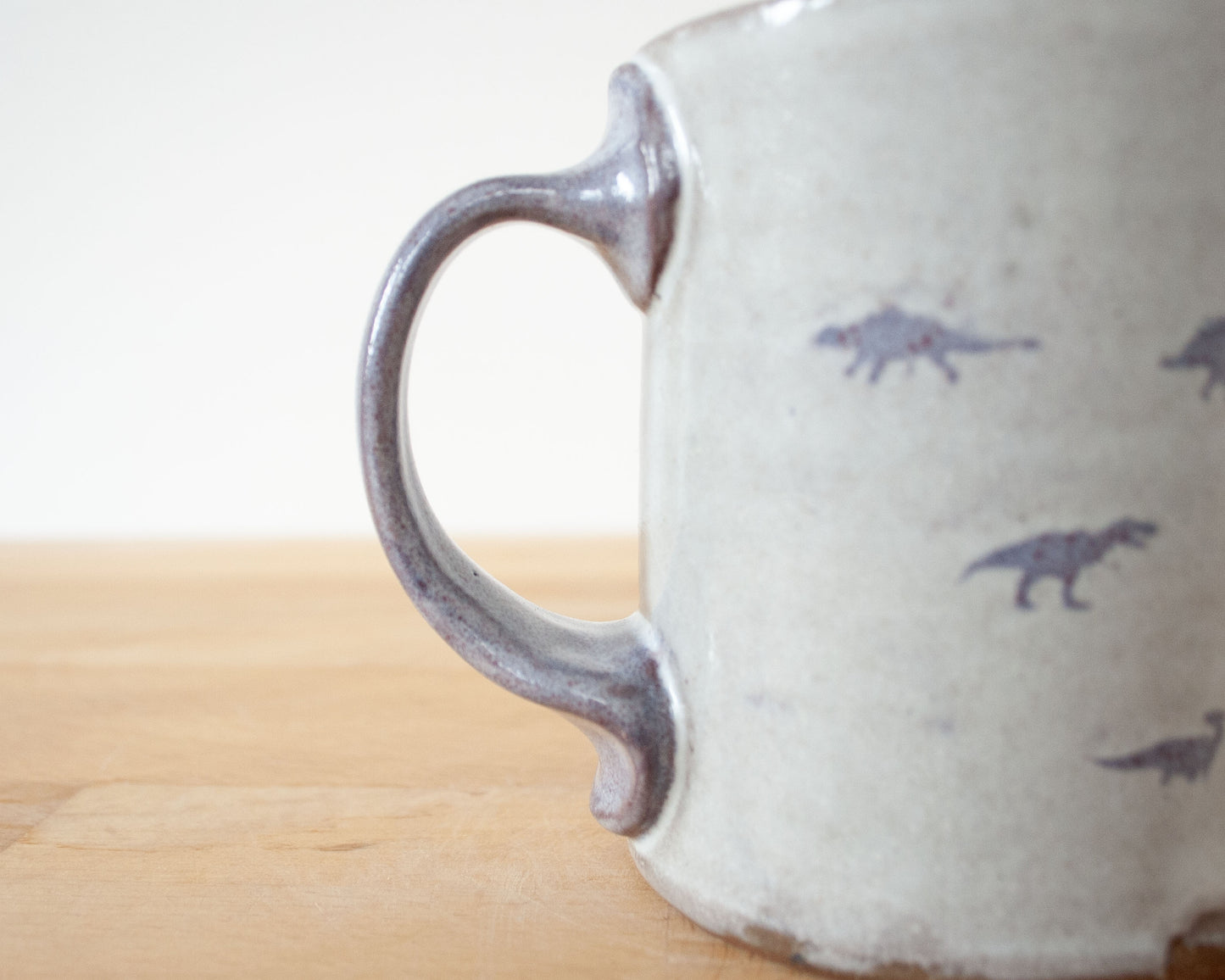 Mug with small purple dinosaurs