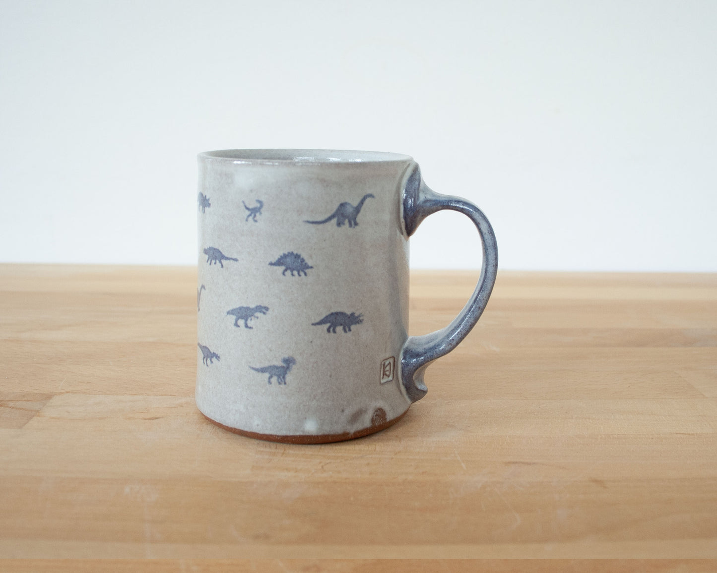 Mug with small blue dinosaurs