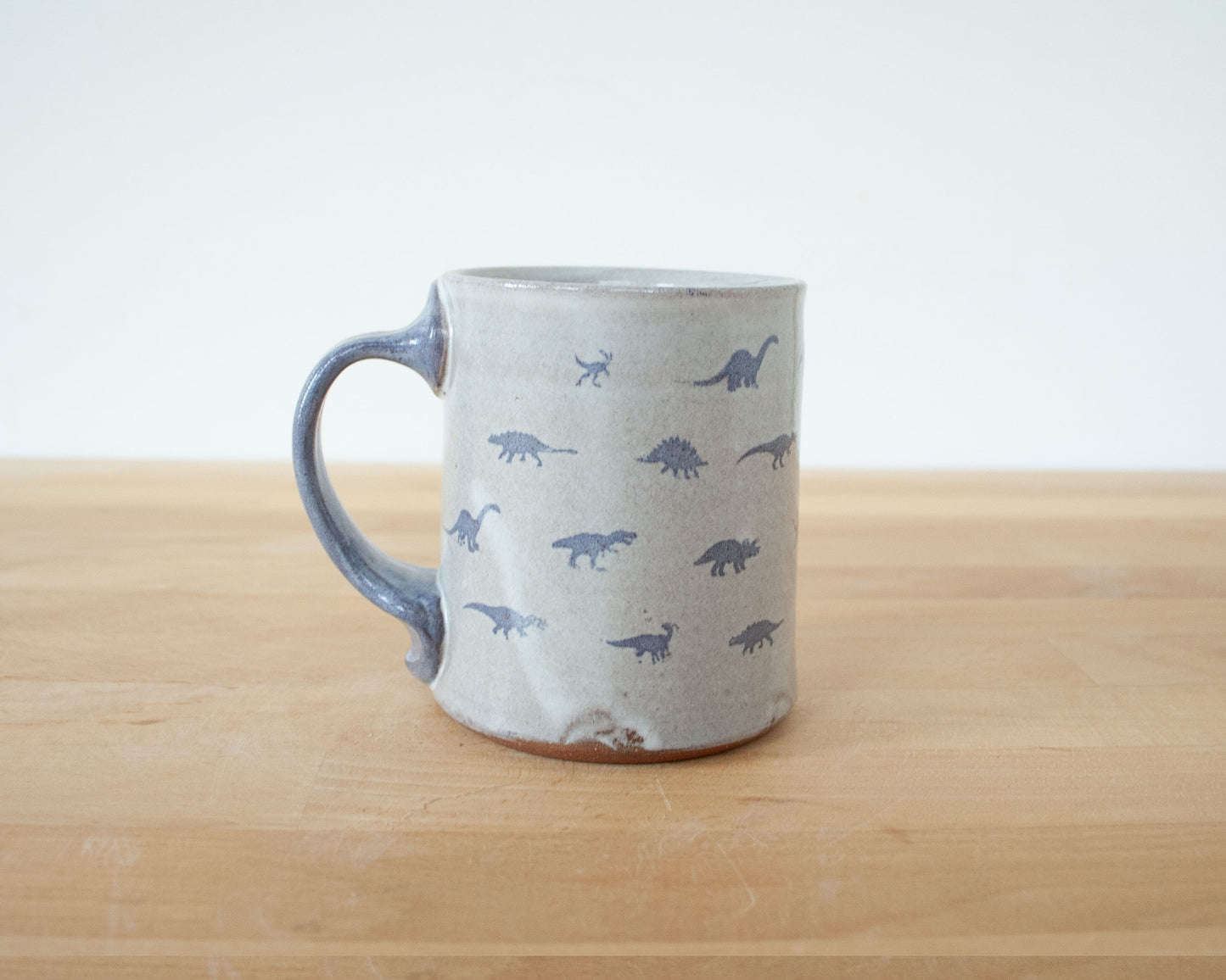 Mug with small blue dinosaurs